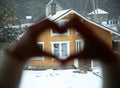 Hands made form of heart, and house on window Royalty Free Stock Photo