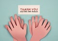 Hands made of paper applaud with the inscription thank you to doctors and nurses