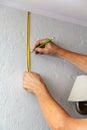 Hands make wall marking with tape measure and pencil Royalty Free Stock Photo
