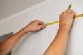 Hands make wall marking with tape measure and pencil Royalty Free Stock Photo