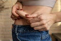 Hands makes fold of skin on stomach Royalty Free Stock Photo