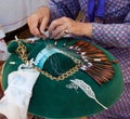 Hands making bobbin lace