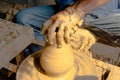 Hands of making clay pot on the pottery wheel ,select focus, close-up. Royalty Free Stock Photo