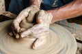 Hands of making clay pot on the pottery wheel ,select focus, close-up. Royalty Free Stock Photo