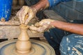 Hands of making clay pot on the pottery wheel ,select focus, close-up. Royalty Free Stock Photo