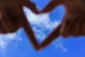 Hands making a heart shape with blur blue sky. Love concept Royalty Free Stock Photo