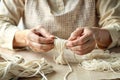 Hands making linen floss Royalty Free Stock Photo