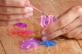 Hands making rubber band bracelet, closeup