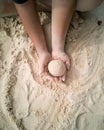 Hands making sphere sand ball by a child at the beach. Play sand Royalty Free Stock Photo