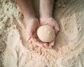 Hands making sphere sand ball by a child at the beach. Play sand Royalty Free Stock Photo