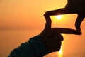 hands making square shape against bright sea sunset Royalty Free Stock Photo