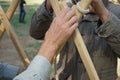 Hands of male builders. Men build Asian yurt frame.