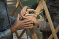 Hands of male builders. Men build Asian yurt frame.