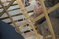 Hands of male builders. Men build Asian yurt frame.