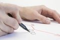 Hands of a male businessman write on a white sheet a growth graph. Growth arrow in 2020. On a white background.