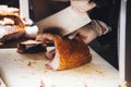 Hands of a Male Chop Roasted Pork with a Meat Cleaver Royalty Free Stock Photo