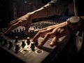 Hands of male dj playing music on modern midi controller turntable digital device for mixing music on events.