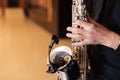 Hands of a male musician saxophonist playing music on a saxophone close up