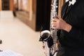 Hands of a male musician saxophonist playing music on a saxophone close up