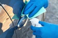 Hands of man in blue protective gloves is spraying disinfectant on handle of car door and wipe with a cloth. Coronavirus or Covid- Royalty Free Stock Photo