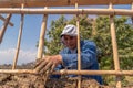 hands a man building a wall with reed and mud, bioconstruction Royalty Free Stock Photo