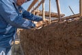 hands a man building a wall with reed and mud Royalty Free Stock Photo