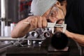 Hands man closeup work in home workshop garage with caliper measure metal pipe fixed to the vise on the work bench, diy and craft