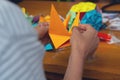 Hands of a man creating a colored origami paper. Royalty Free Stock Photo