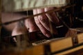 A hands of a man delicately working a model of a miniature ship piece by piece Royalty Free Stock Photo