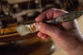 A hands of a man delicately working a model of a miniature ship piece by piece Royalty Free Stock Photo