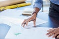 Hands, man and drawing on blueprint in office with pencil for planning a building design, layout and project as Royalty Free Stock Photo