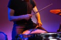 Hands of man drummer sitting and playing drums with drumsticks Royalty Free Stock Photo