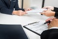 Hands of man giving application portfolio to HR man in office for interview.