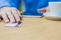 Hands of man giving plastic card to waiter to pay for the order. Royalty Free Stock Photo