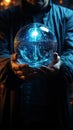 Hands of a man holding a glass sphere with luminous dots inside