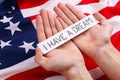 Hands of a man holding a sign with the inscription I have a dream. Against the background of the American flag.