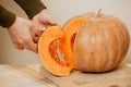 Hands of man holding piece of ripe pumpkin close-up Royalty Free Stock Photo