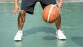 The hands of a man knock basketball on a green background with the 2 side at the BangYai park , Nonthaburi in Thailand. June 2, 20