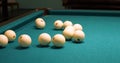 The hands of a man lay out white billiard balls on a green table. The beginning of the game in Russian billiards. White Royalty Free Stock Photo