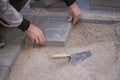 Hands of a man laying pavers or tiles in sand Royalty Free Stock Photo