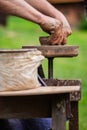 The hands of a man making pottery using a traditional method. Royalty Free Stock Photo