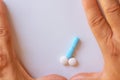 Hands of a man next to pills that symbolize a penis with an erection. Metaphor of male virility. Medicine related to male