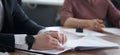 Hands of a man - an official or a businessman in an elegant suit, next to a document, during a workshop. No face. Boss, deputy,