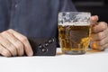 Hands of the man in one hand hold the key card in the car, in the second mug with beer. Royalty Free Stock Photo