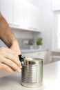 Man opening a can in white kitchen Royalty Free Stock Photo