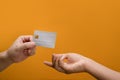 Hands of man passing a payment credit card to the seller. Electronic money, transection and banking concept Royalty Free Stock Photo