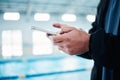 Hands, man and phone for texting by swimming pool for communication, social media or contact on web. Aquatic sports Royalty Free Stock Photo