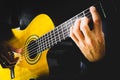 Hands of a man playing acoustic guitar on a black background Royalty Free Stock Photo