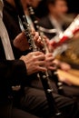 Hands of man playing the clarinet in the orchestra