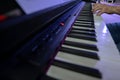 hands of man playing electric piano. black digital keyboard in perspective. to use as a background for presentations or banners. Royalty Free Stock Photo